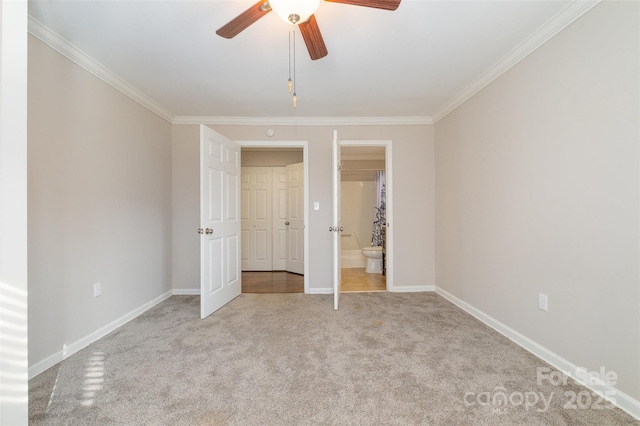 unfurnished bedroom featuring ceiling fan, ornamental molding, ensuite bathroom, and light carpet