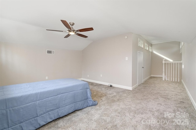 bedroom with ceiling fan, light colored carpet, and lofted ceiling