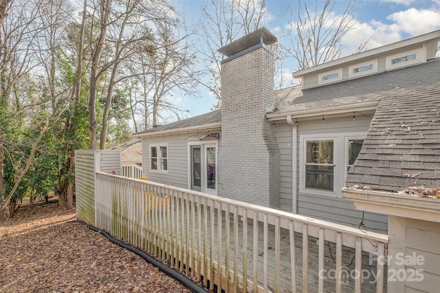 rear view of property featuring a deck