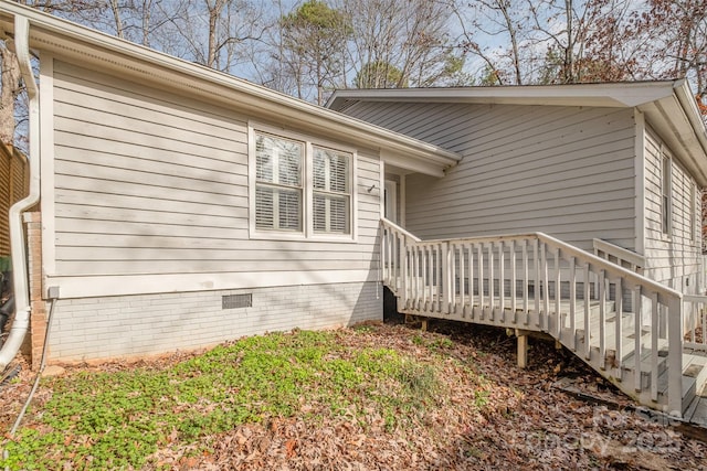 view of side of property featuring a wooden deck