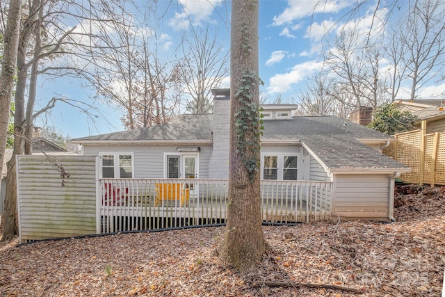 rear view of house featuring a wooden deck