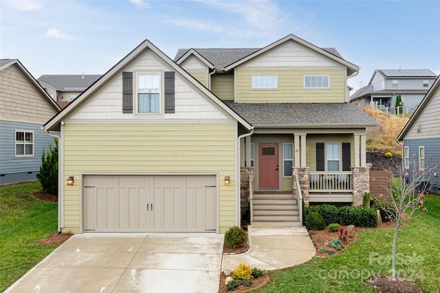 craftsman-style home with covered porch, a garage, and a front lawn