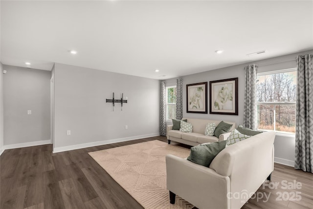 living room with dark hardwood / wood-style flooring and plenty of natural light