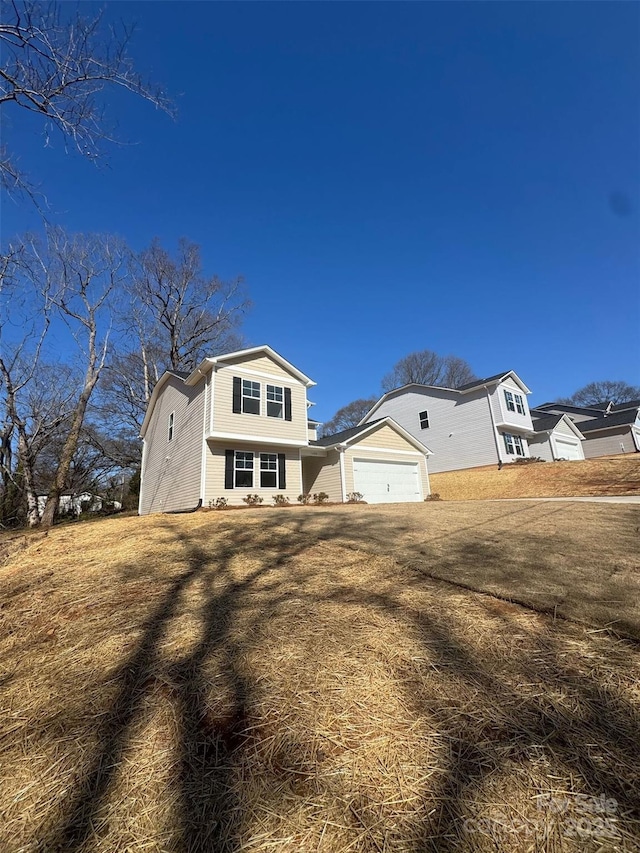 exterior space with a garage and a front lawn