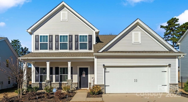 view of front of house with a porch and a garage