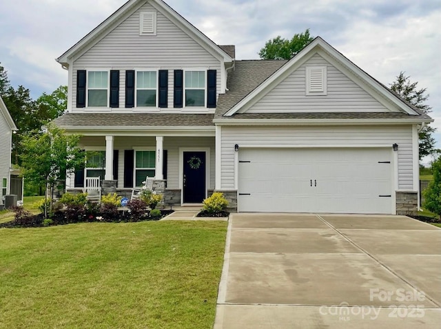 craftsman-style home featuring stone siding, a porch, concrete driveway, and a front yard