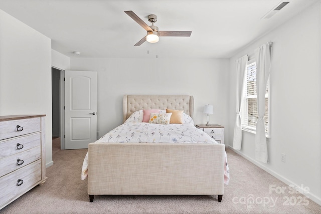 bedroom featuring a ceiling fan, light colored carpet, visible vents, and baseboards