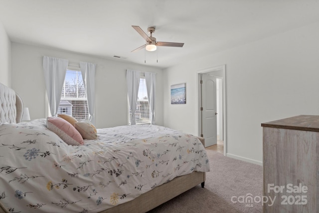 bedroom featuring carpet floors, baseboards, visible vents, and ceiling fan