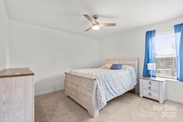 bedroom featuring baseboards, ceiling fan, and light colored carpet