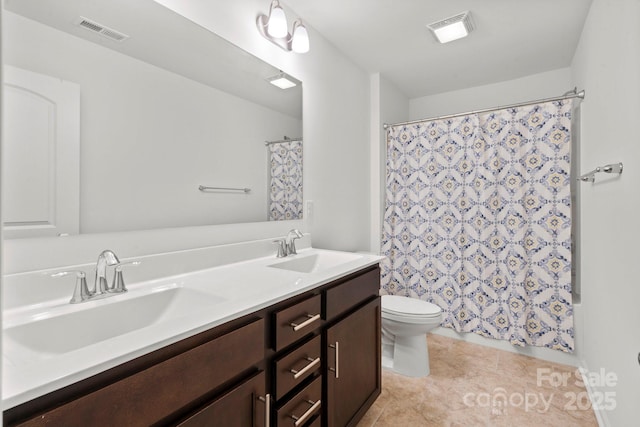 bathroom with tile patterned flooring, a sink, and visible vents