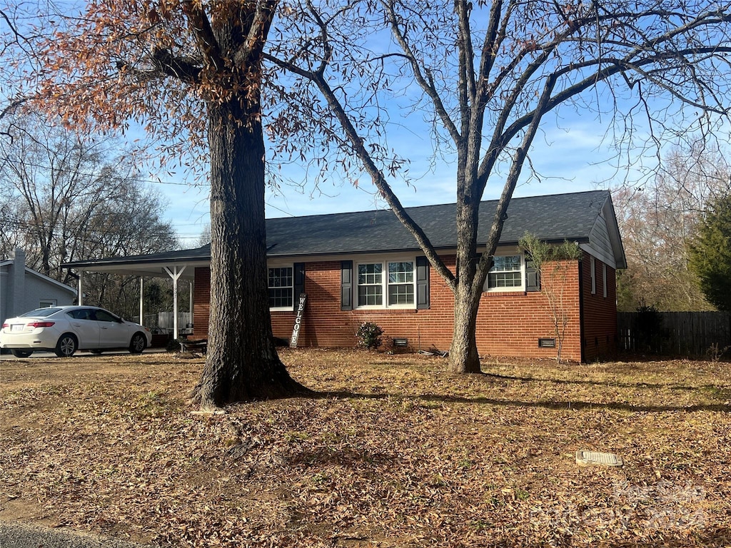 single story home featuring a carport