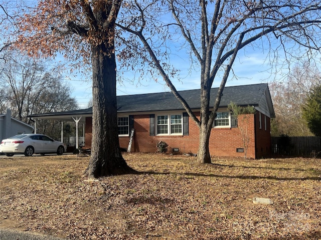 single story home featuring a carport