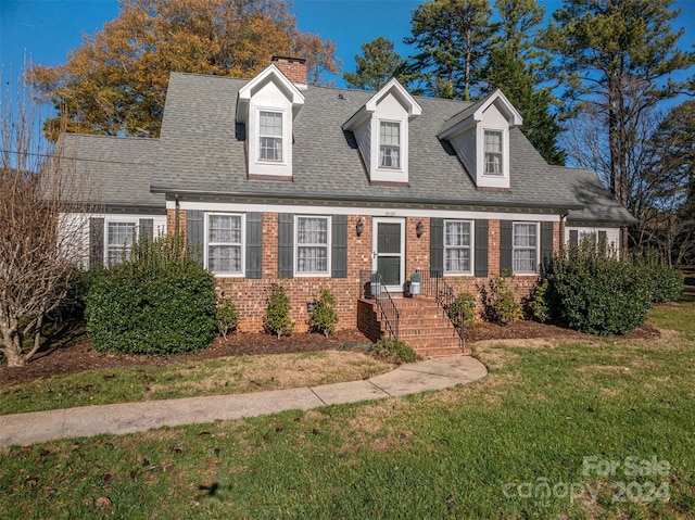 new england style home with a front lawn