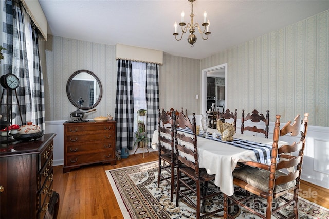 dining space with a notable chandelier and wood-type flooring