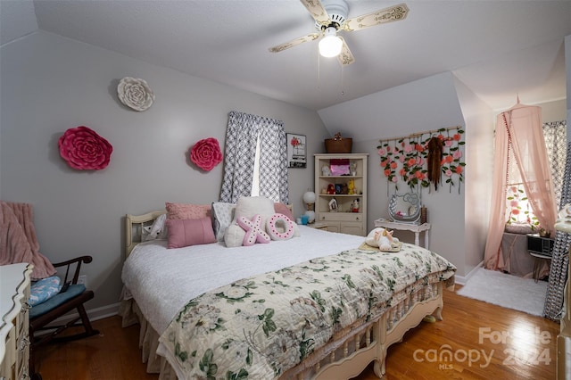 bedroom featuring ceiling fan, wood-type flooring, and lofted ceiling