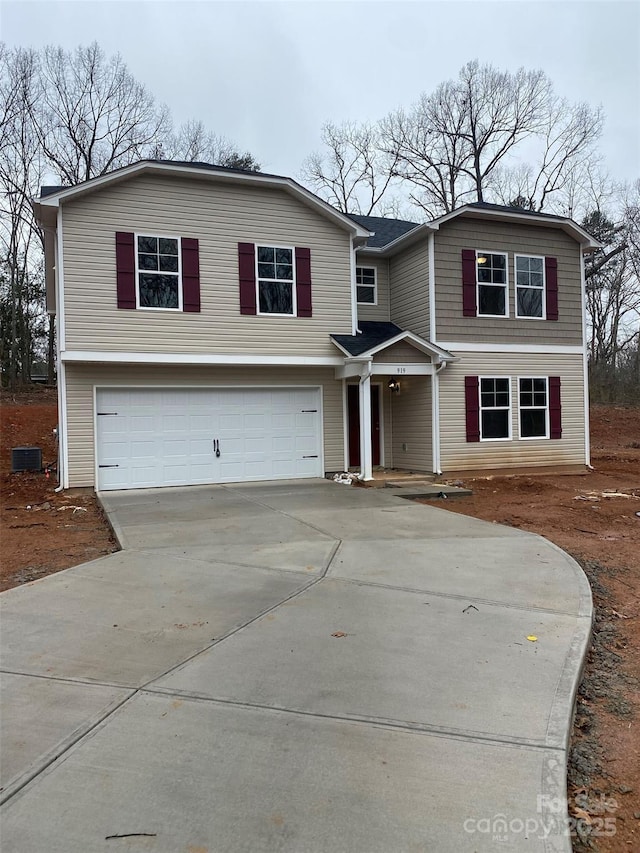 view of front of property featuring cooling unit and a garage