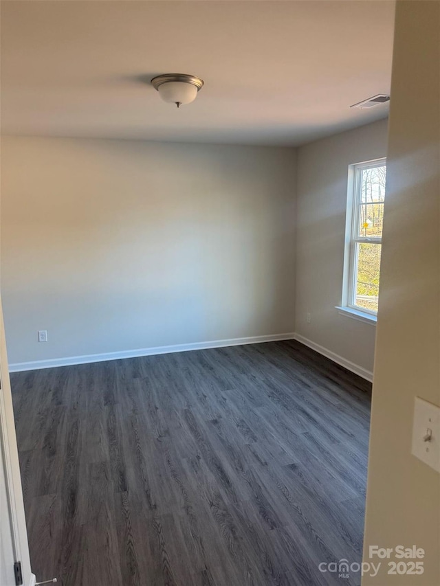 empty room featuring dark hardwood / wood-style floors