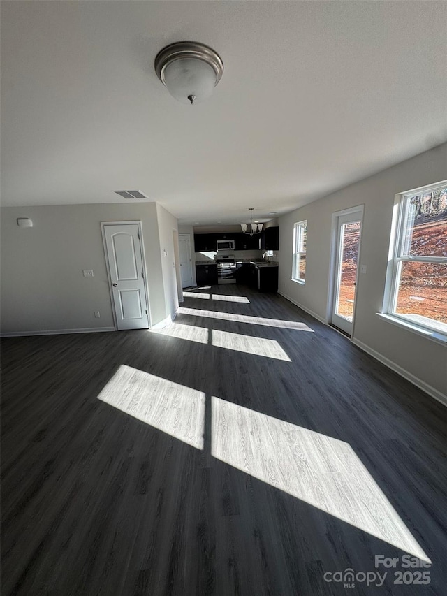 unfurnished living room featuring dark hardwood / wood-style flooring