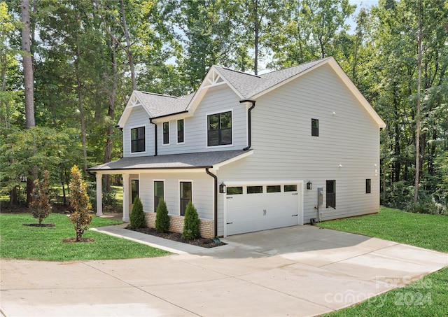 view of front of property with a garage and a front yard