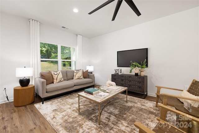 living room with hardwood / wood-style flooring and ceiling fan