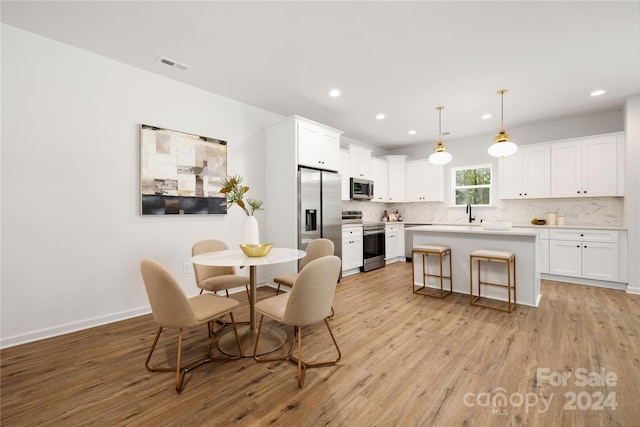 dining room with light hardwood / wood-style flooring