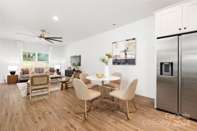 dining space with ceiling fan and light hardwood / wood-style floors