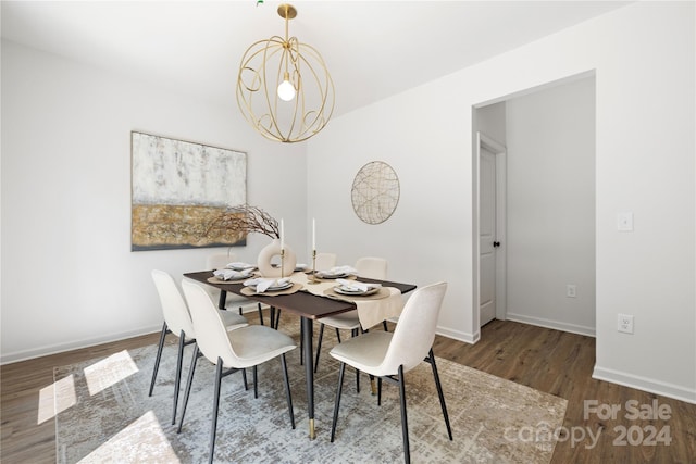 dining room featuring hardwood / wood-style floors and a notable chandelier