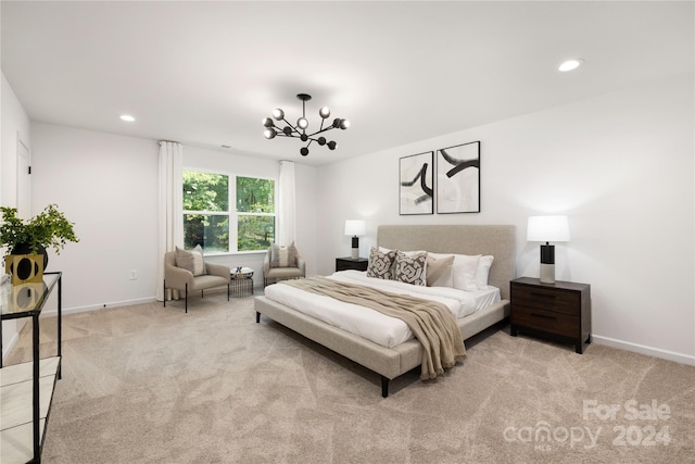 bedroom featuring a chandelier and light colored carpet