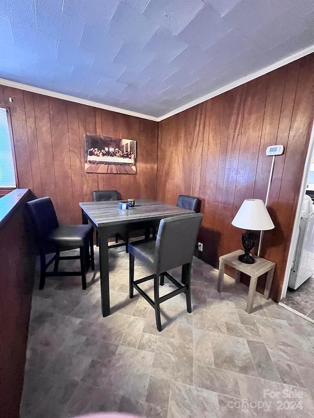 dining room with wooden walls