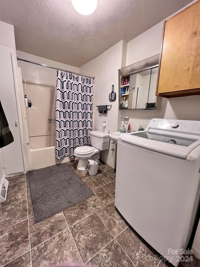 full bathroom featuring shower / bath combination with curtain, toilet, washer / dryer, and a textured ceiling