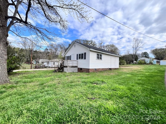 view of property exterior with a lawn