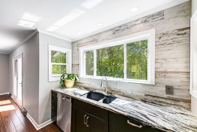 kitchen with light stone countertops, dark brown cabinets, sink, dishwasher, and dark hardwood / wood-style floors