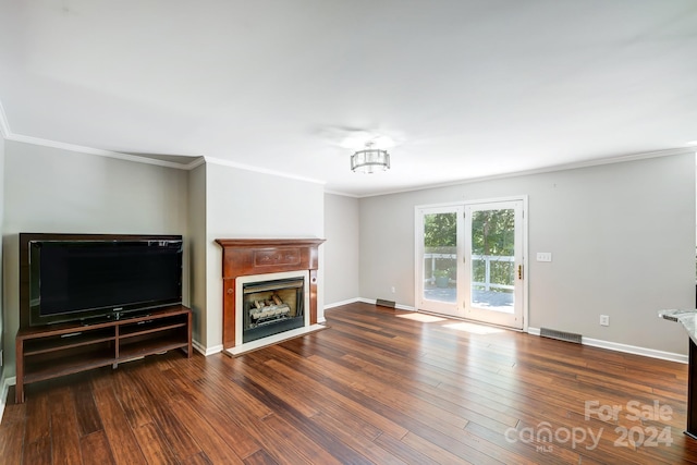 unfurnished living room with crown molding and dark wood-type flooring