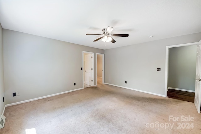 carpeted spare room with ceiling fan