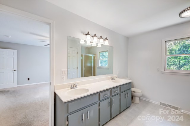 bathroom with tile patterned flooring, plenty of natural light, ceiling fan, and a shower with shower door