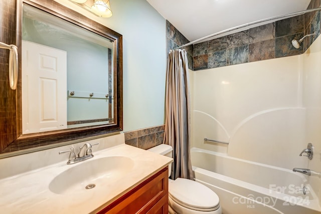 full bathroom featuring shower / tub combo with curtain, vanity, tile walls, and toilet