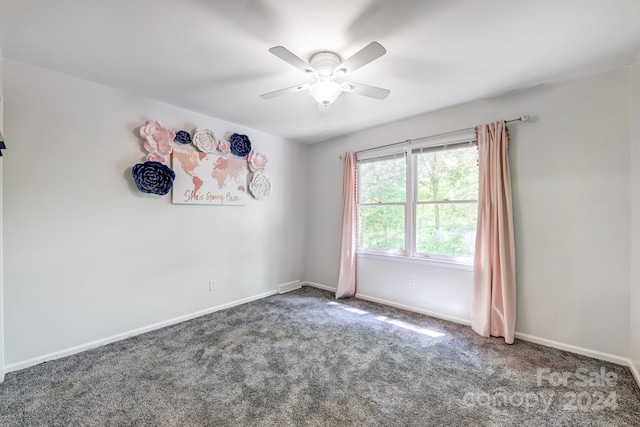 carpeted empty room featuring ceiling fan