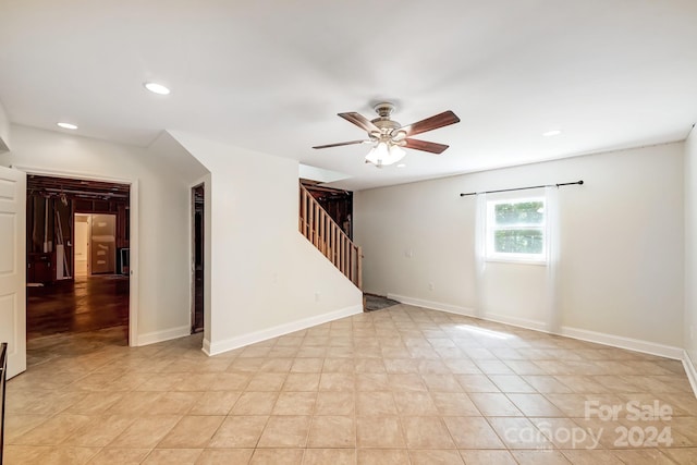 tiled empty room with ceiling fan