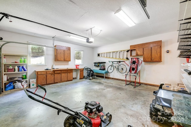 garage with a workshop area and a garage door opener