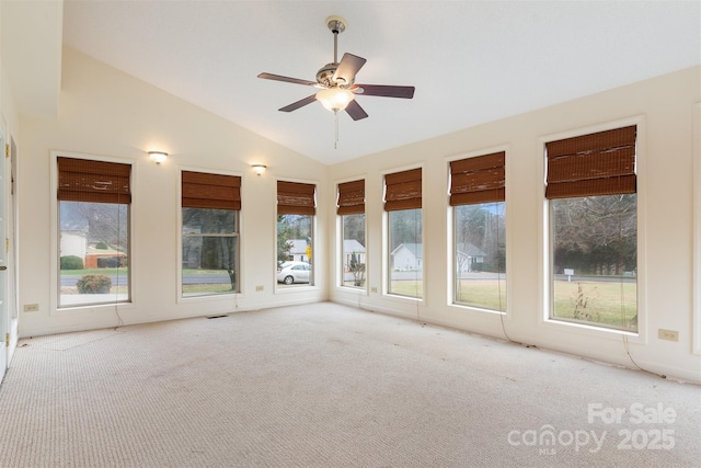 unfurnished sunroom with ceiling fan and lofted ceiling