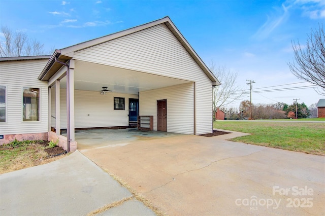 view of home's exterior featuring a lawn and a carport