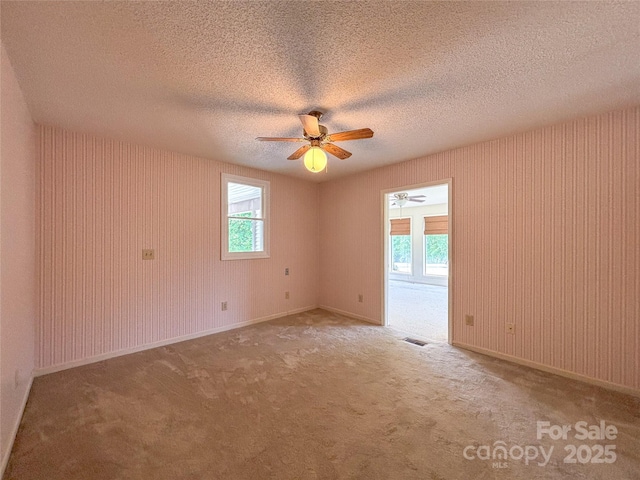 9566 Wilson Rd, Hildebran, NC 28637 - empty room with a ceiling fan, a textured ceiling, and carpet