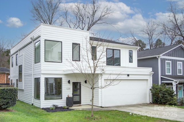 view of front of property with a garage and a front lawn