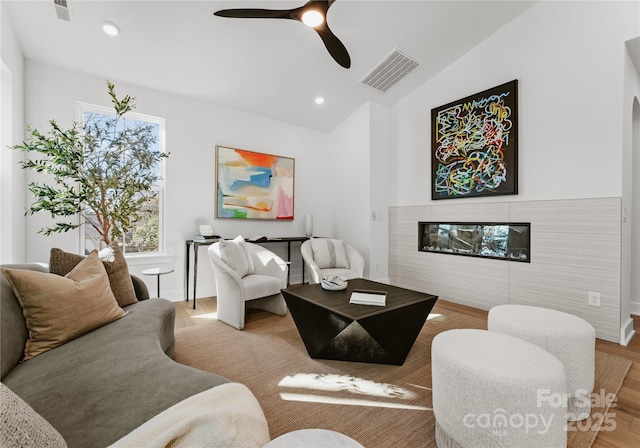 living room featuring vaulted ceiling and ceiling fan