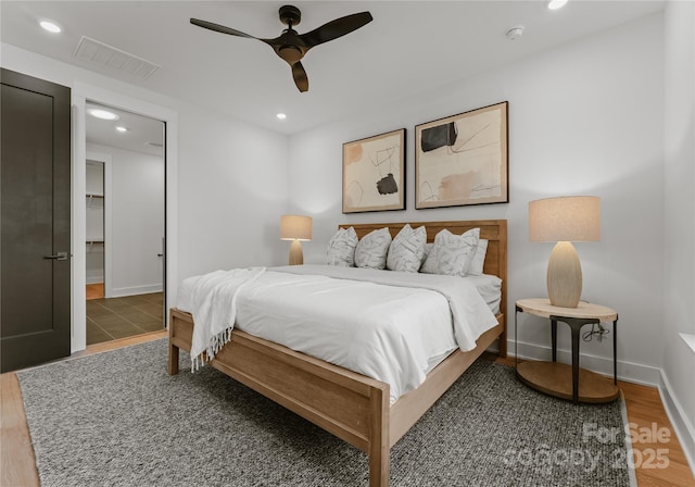 bedroom with ceiling fan and dark hardwood / wood-style flooring