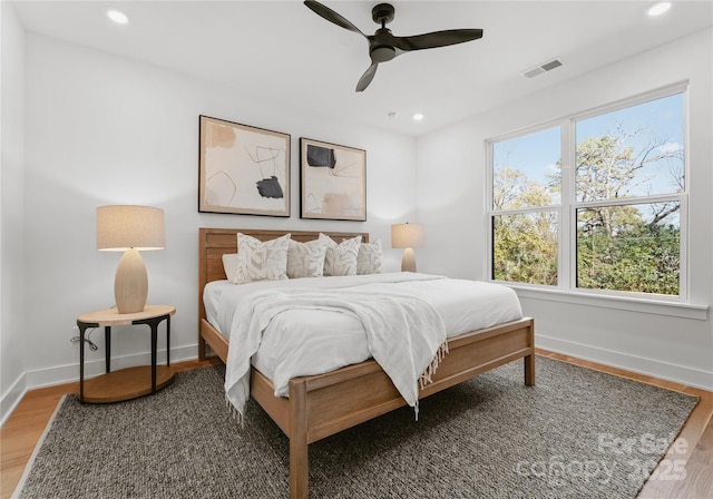 bedroom featuring dark hardwood / wood-style flooring and ceiling fan