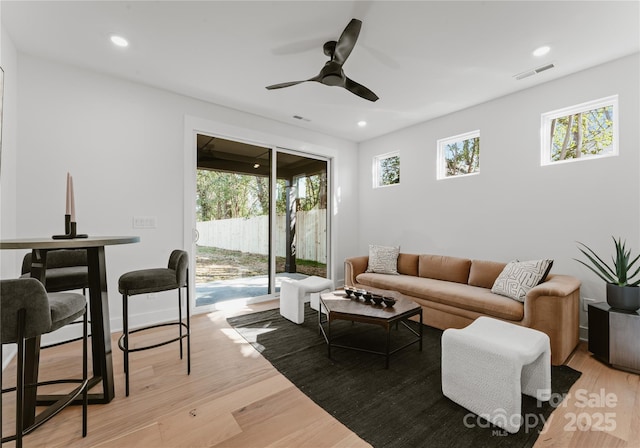 living room with ceiling fan and light wood-type flooring