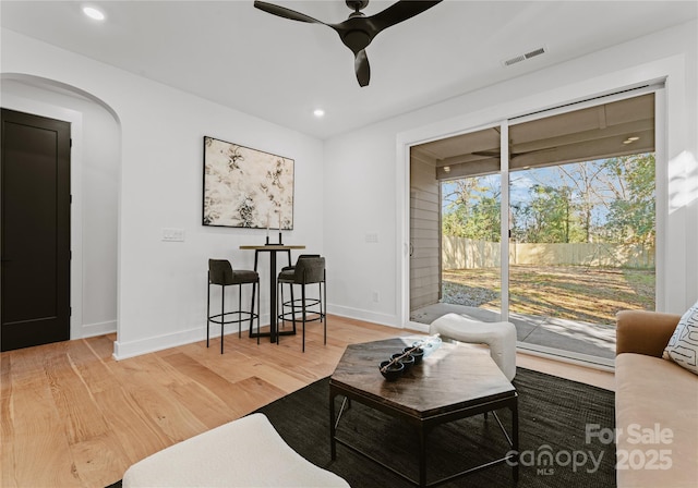 living room featuring ceiling fan and hardwood / wood-style floors