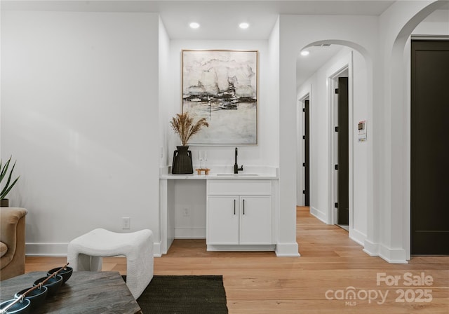 hall featuring light hardwood / wood-style flooring and sink