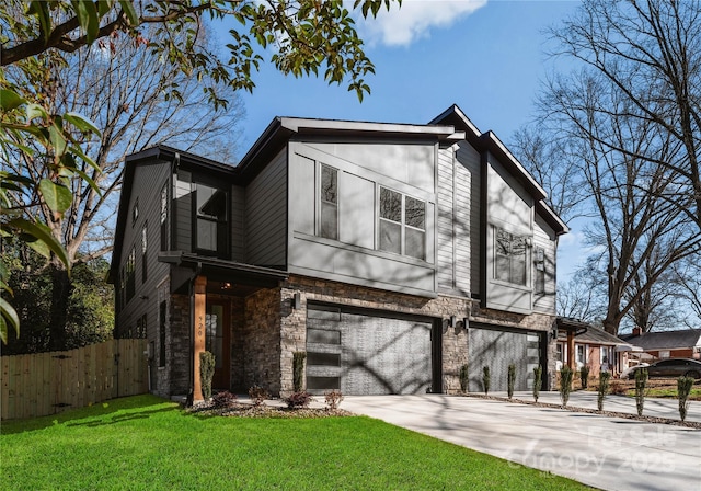 contemporary house featuring a front lawn and a garage